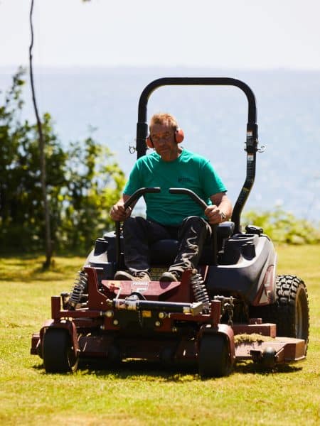 passage d'une tondeuse autoportée sur un jardin bord de mer